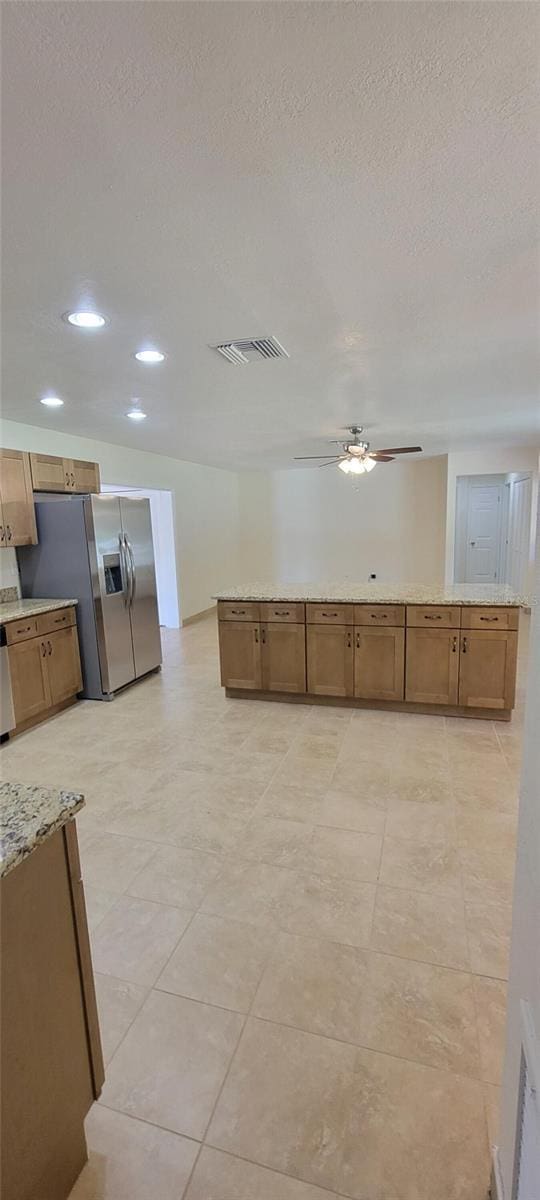 122 N Cedarview Ter, Inverness, FL 34453 - kitchen with appliances with stainless steel finishes, ceiling fan, recessed lighting, a textured ceiling, and brown cabinetry