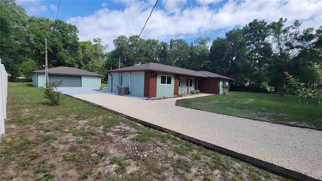 122 N Cedarview Ter, Inverness, FL 34453 - view of front of house featuring a front lawn, a detached garage, cooling unit, and an outdoor structure