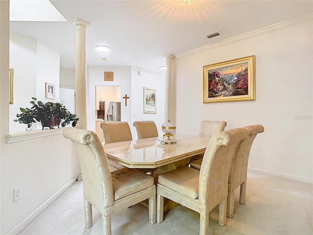 7323 Cypress Grove Rd Unit 87, Orlando, FL 32819 - dining room featuring ornate columns, baseboards, and light carpet