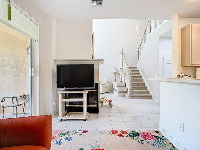 7323 Cypress Grove Rd Unit 87, Orlando, FL 32819 - living room featuring light tile patterned floors and stairs