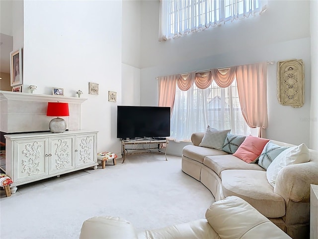 7323 Cypress Grove Rd Unit 87, Orlando, FL 32819 - carpeted living area with a towering ceiling and healthy amount of natural light