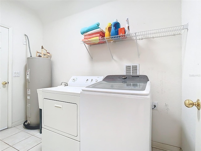 7323 Cypress Grove Rd Unit 87, Orlando, FL 32819 - laundry area featuring electric water heater, separate washer and dryer, and light tile patterned flooring