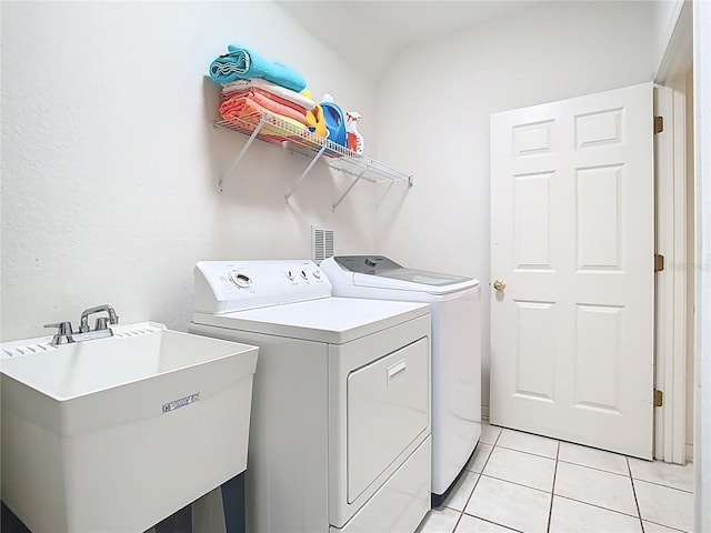 7323 Cypress Grove Rd Unit 87, Orlando, FL 32819 - laundry area featuring separate washer and dryer and light tile patterned floors