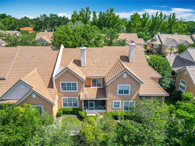 7323 Cypress Grove Rd Unit 87, Orlando, FL 32819 - back of house with a chimney, a sunroom, stucco siding, and a residential view