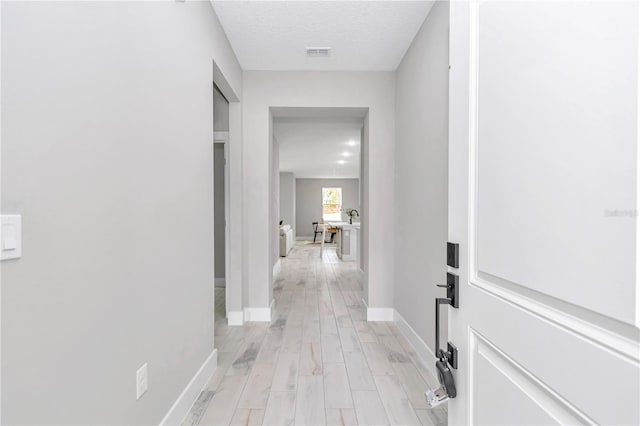 6805 SW 131st Cir, Ocala, FL 34481 - hallway with baseboards and light wood-style floors