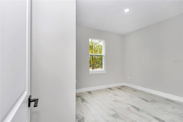 6805 SW 131st Cir, Ocala, FL 34481 - unfurnished room with a textured ceiling, baseboards, recessed lighting, and light wood finished floors