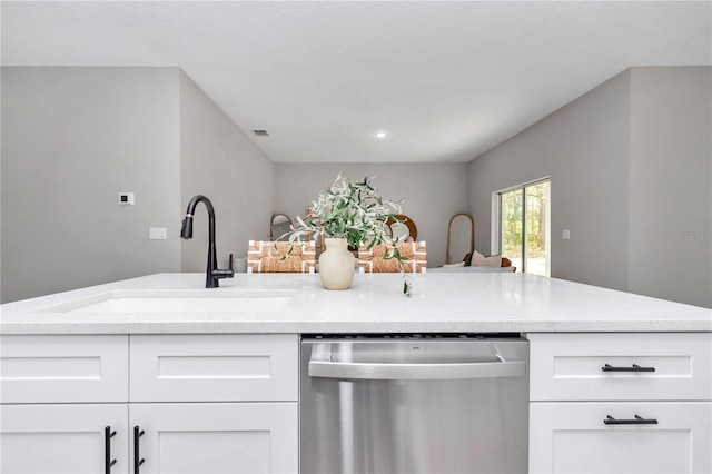 6805 SW 131st Cir, Ocala, FL 34481 - kitchen with stainless steel dishwasher, a sink, light stone counters, and white cabinets