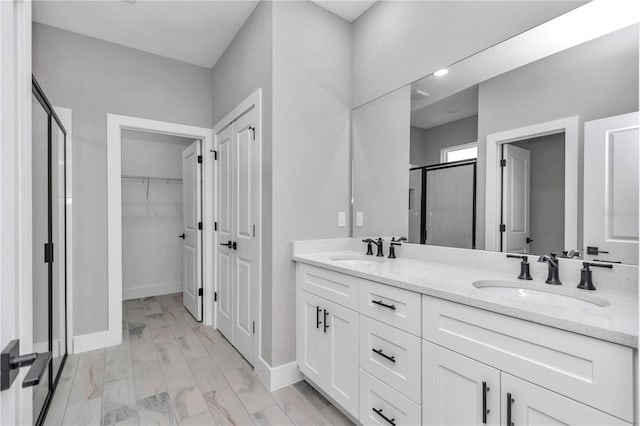 6805 SW 131st Cir, Ocala, FL 34481 - full bathroom featuring a shower stall, a spacious closet, double vanity, and baseboards