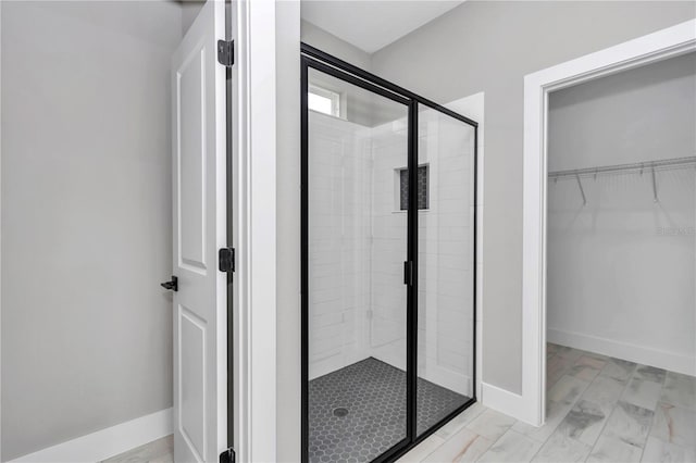 6805 SW 131st Cir, Ocala, FL 34481 - full bath featuring a shower stall, a walk in closet, and baseboards