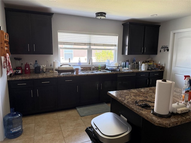 6800 SE 12th Pl, Ocala, FL 34472 - kitchen with a sink, dark cabinets, light tile patterned floors, and dark stone counters