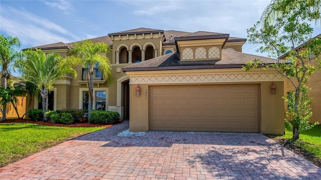 3041 Boating Blvd, Kissimmee, FL 34746 - mediterranean / spanish-style house with stucco siding, driveway, an attached garage, and a balcony