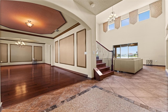 3041 Boating Blvd, Kissimmee, FL 34746 - entrance foyer with a chandelier, a textured ceiling, plenty of natural light, stairway, and a towering ceiling