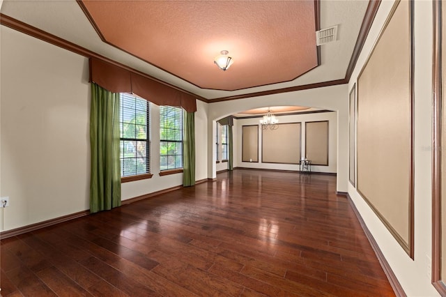 3041 Boating Blvd, Kissimmee, FL 34746 - spare room featuring arched walkways, a chandelier, a textured ceiling, ornamental molding, and wood-type flooring