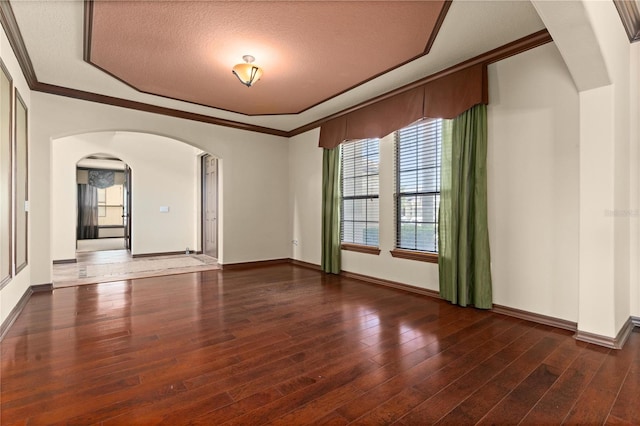 3041 Boating Blvd, Kissimmee, FL 34746 - unfurnished room featuring arched walkways, wood finished floors, baseboards, a textured ceiling, and crown molding