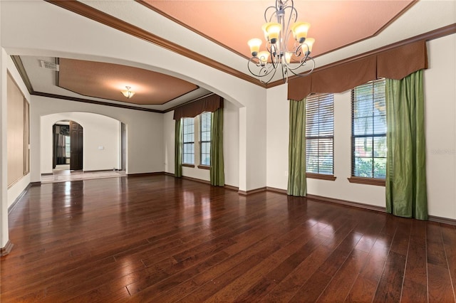 3041 Boating Blvd, Kissimmee, FL 34746 - spare room featuring a chandelier, arched walkways, a tray ceiling, crown molding, and hardwood / wood-style floors