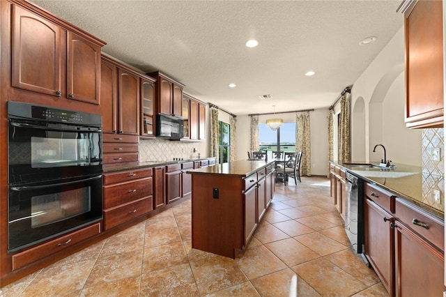 3041 Boating Blvd, Kissimmee, FL 34746 - kitchen featuring black appliances, a center island, dark countertops, recessed lighting, and decorative backsplash