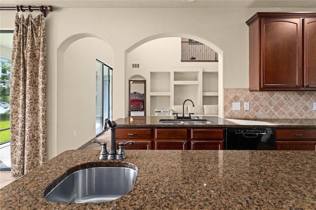 3041 Boating Blvd, Kissimmee, FL 34746 - kitchen featuring a sink, dishwasher, and dark stone counters