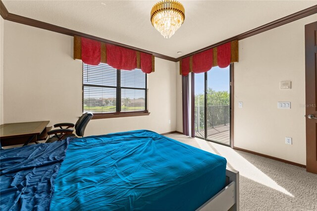 3041 Boating Blvd, Kissimmee, FL 34746 - carpeted bedroom featuring access to exterior, crown molding, baseboards, and a chandelier