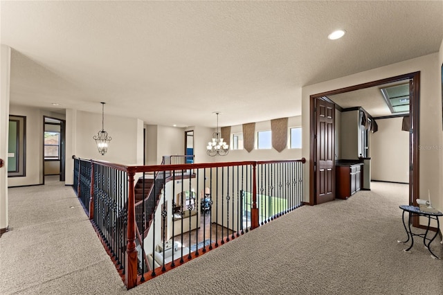 3041 Boating Blvd, Kissimmee, FL 34746 - corridor featuring a chandelier, light colored carpet, a textured ceiling, baseboards, and recessed lighting