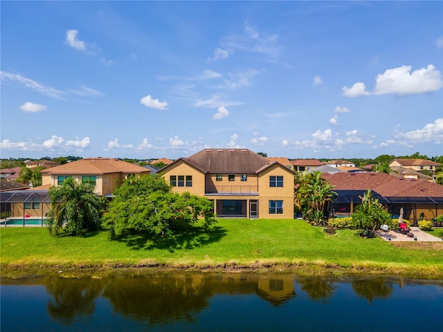 3041 Boating Blvd, Kissimmee, FL 34746 - back of house featuring a residential view, a water view, and a yard
