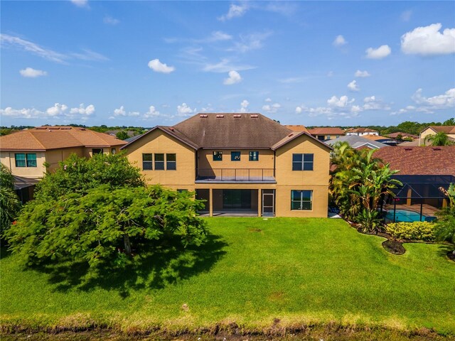 3041 Boating Blvd, Kissimmee, FL 34746 - rear view of property with a balcony, stucco siding, a yard, and a residential view