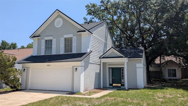 609 Whittingham Pl, Lake Mary, FL 32746 - view of front facade with a shingled roof, stucco siding, an attached garage, and driveway
