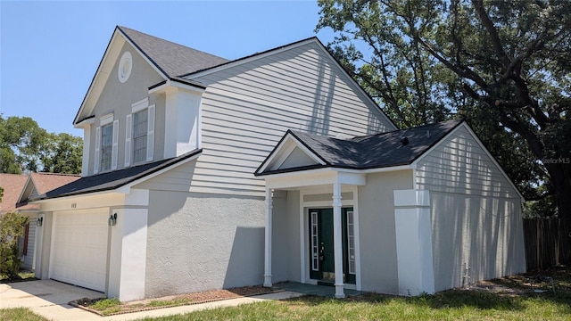 609 Whittingham Pl, Lake Mary, FL 32746 - view of home's exterior featuring stucco siding, a shingled roof, and driveway