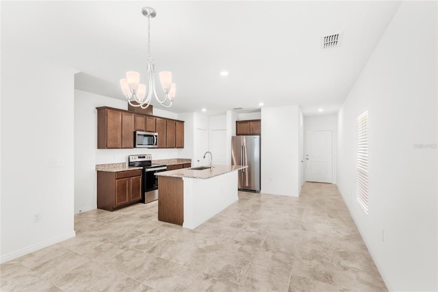1396 Mirabella Cir, Davenport, FL 33897 - kitchen featuring appliances with stainless steel finishes, a sink, a chandelier, an island with sink, and hanging light fixtures