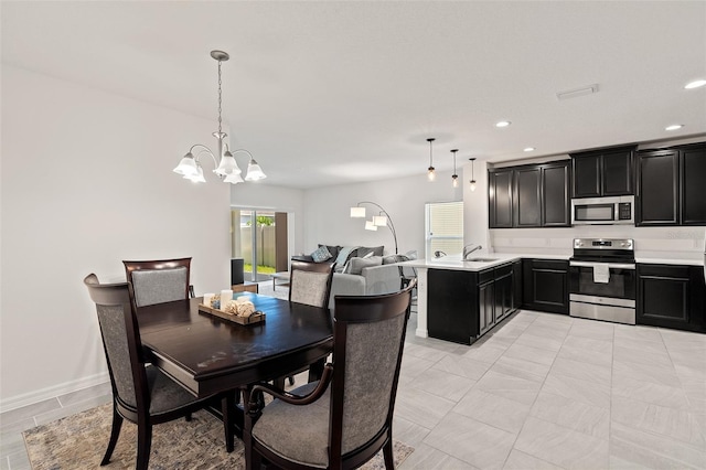 9356 St Therese St, Groveland, FL 34736 - dining space with a chandelier and recessed lighting