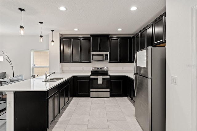 9356 St Therese St, Groveland, FL 34736 - kitchen featuring stainless steel appliances, a sink, dark cabinetry, and recessed lighting