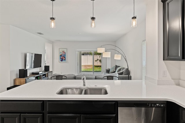 9356 St Therese St, Groveland, FL 34736 - kitchen featuring dishwasher, open floor plan, a sink, dark cabinetry, and light countertops