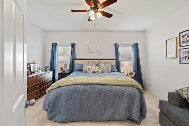 9356 St Therese St, Groveland, FL 34736 - bedroom with light colored carpet, ceiling fan, and baseboards