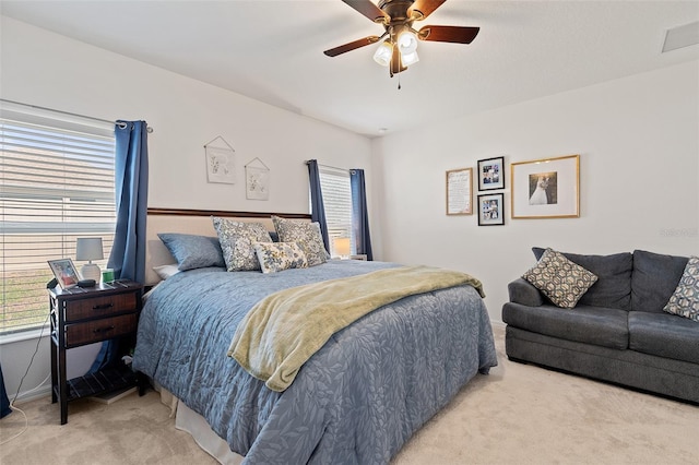 9356 St Therese St, Groveland, FL 34736 - bedroom with light colored carpet, multiple windows, and ceiling fan