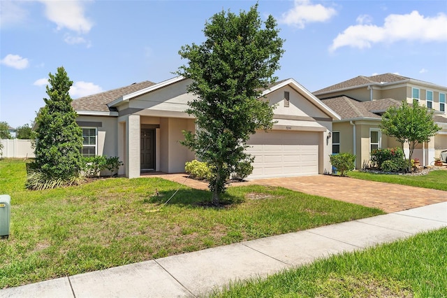 9356 St Therese St, Groveland, FL 34736 - view of front of property with a garage, stucco siding, driveway, and a shingled roof