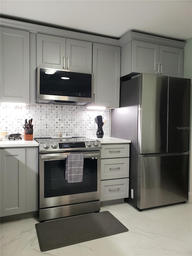 983 Bucksaw Pl, Longwood, FL 32750 - kitchen with appliances with stainless steel finishes, gray cabinetry, light marble finish flooring, and light countertops