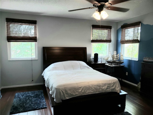 983 Bucksaw Pl, Longwood, FL 32750 - bedroom with baseboards, wood finished floors, a textured ceiling, and ceiling fan