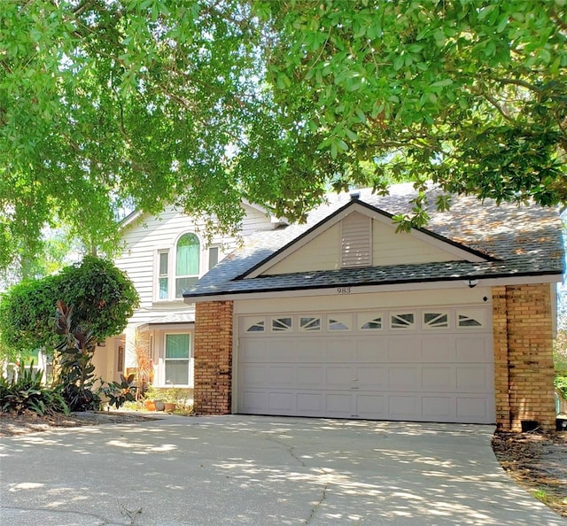 983 Bucksaw Pl, Longwood, FL 32750 - view of front of house featuring driveway, a garage, and brick siding
