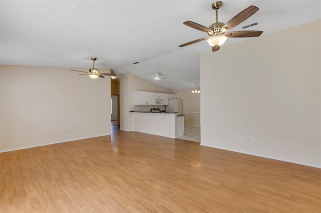2714 Moncayo Ave, The Villages, FL 32162 - unfurnished living room featuring ceiling fan, light wood-type flooring, lofted ceiling, and baseboards