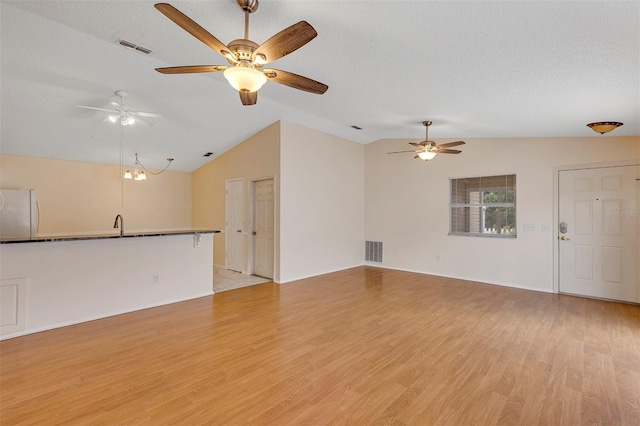 2714 Moncayo Ave, The Villages, FL 32162 - unfurnished living room featuring vaulted ceiling, a ceiling fan, light wood-style flooring, and baseboards