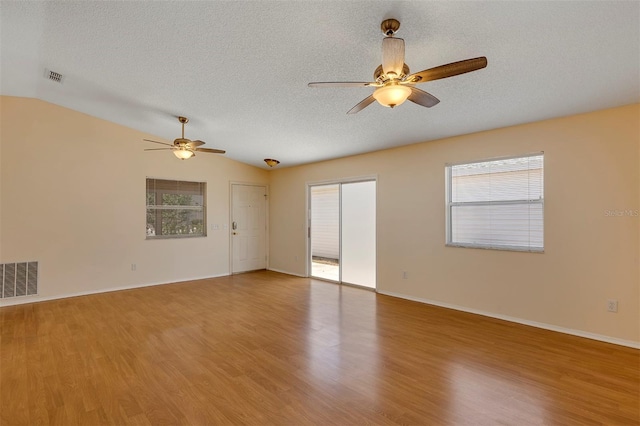 2714 Moncayo Ave, The Villages, FL 32162 - unfurnished room featuring ceiling fan, light wood finished floors, a textured ceiling, vaulted ceiling, and baseboards