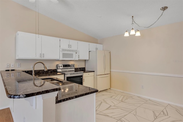 2714 Moncayo Ave, The Villages, FL 32162 - kitchen with white appliances, a sink, dark stone countertops, a peninsula, and vaulted ceiling