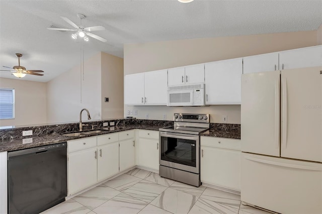 2714 Moncayo Ave, The Villages, FL 32162 - kitchen featuring white appliances, a sink, lofted ceiling, ceiling fan, and dark stone countertops