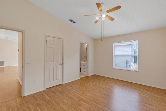 2714 Moncayo Ave, The Villages, FL 32162 - unfurnished bedroom with light wood-style flooring, lofted ceiling, baseboards, connected bathroom, and a ceiling fan