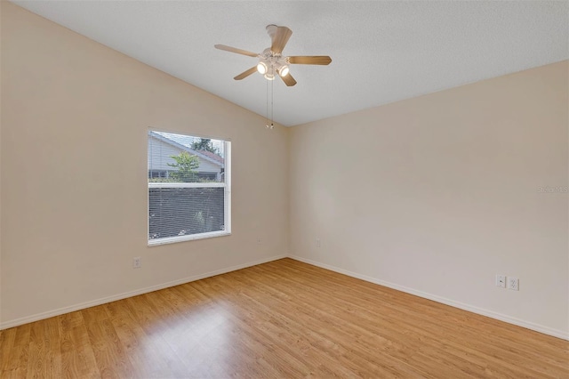 2714 Moncayo Ave, The Villages, FL 32162 - empty room featuring light wood finished floors, baseboards, a ceiling fan, and vaulted ceiling
