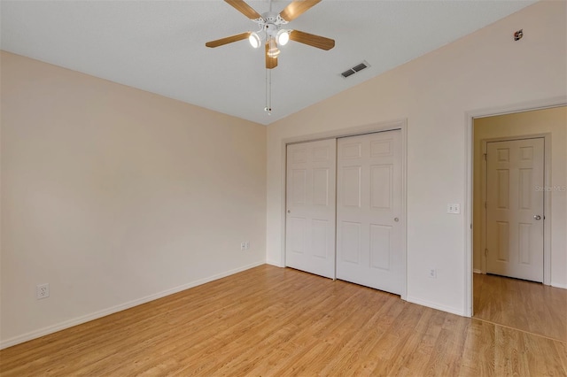 2714 Moncayo Ave, The Villages, FL 32162 - unfurnished bedroom featuring vaulted ceiling, light wood-style floors, baseboards, a closet, and a ceiling fan