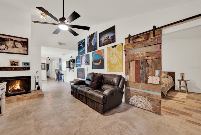 8248 Limetree Ct, Orlando, FL 32836 - living area with ceiling fan, a warm lit fireplace, high vaulted ceiling, and a barn door