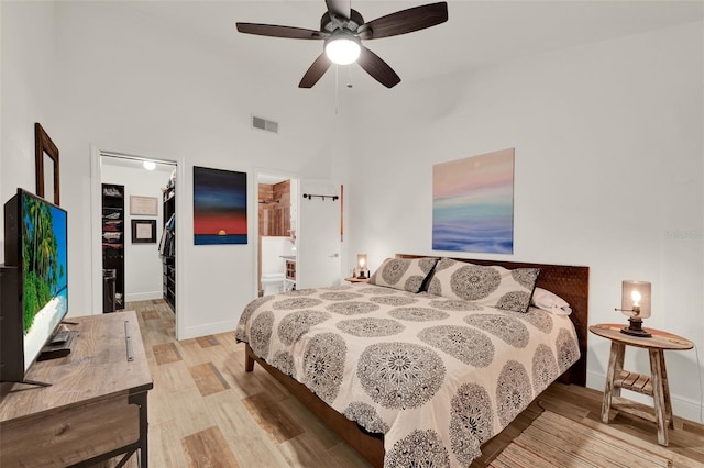 8248 Limetree Ct, Orlando, FL 32836 - bedroom featuring a spacious closet, wood finished floors, baseboards, a closet, and a high ceiling
