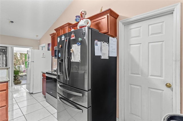 14 Sequoia Way, Kissimmee, FL 34758 - kitchen featuring stainless steel appliances, lofted ceiling, light tile patterned flooring, light stone counters, and brown cabinets