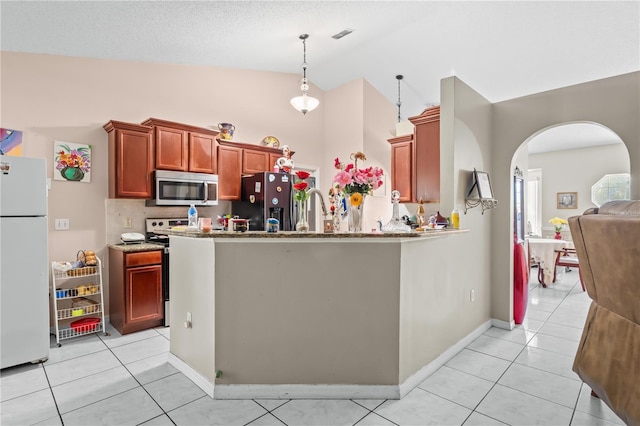 14 Sequoia Way, Kissimmee, FL 34758 - kitchen with appliances with stainless steel finishes, arched walkways, light tile patterned flooring, high vaulted ceiling, and baseboards