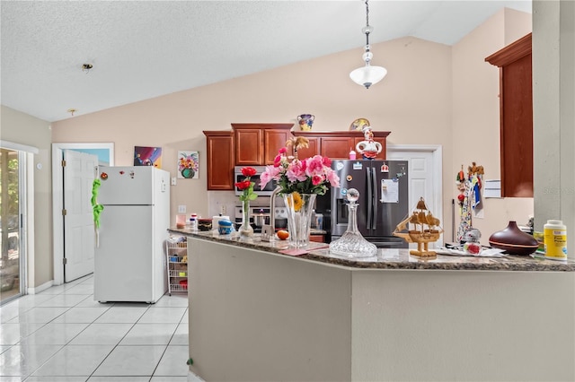 14 Sequoia Way, Kissimmee, FL 34758 - kitchen with freestanding refrigerator, vaulted ceiling, stainless steel fridge with ice dispenser, dark stone countertops, and decorative light fixtures